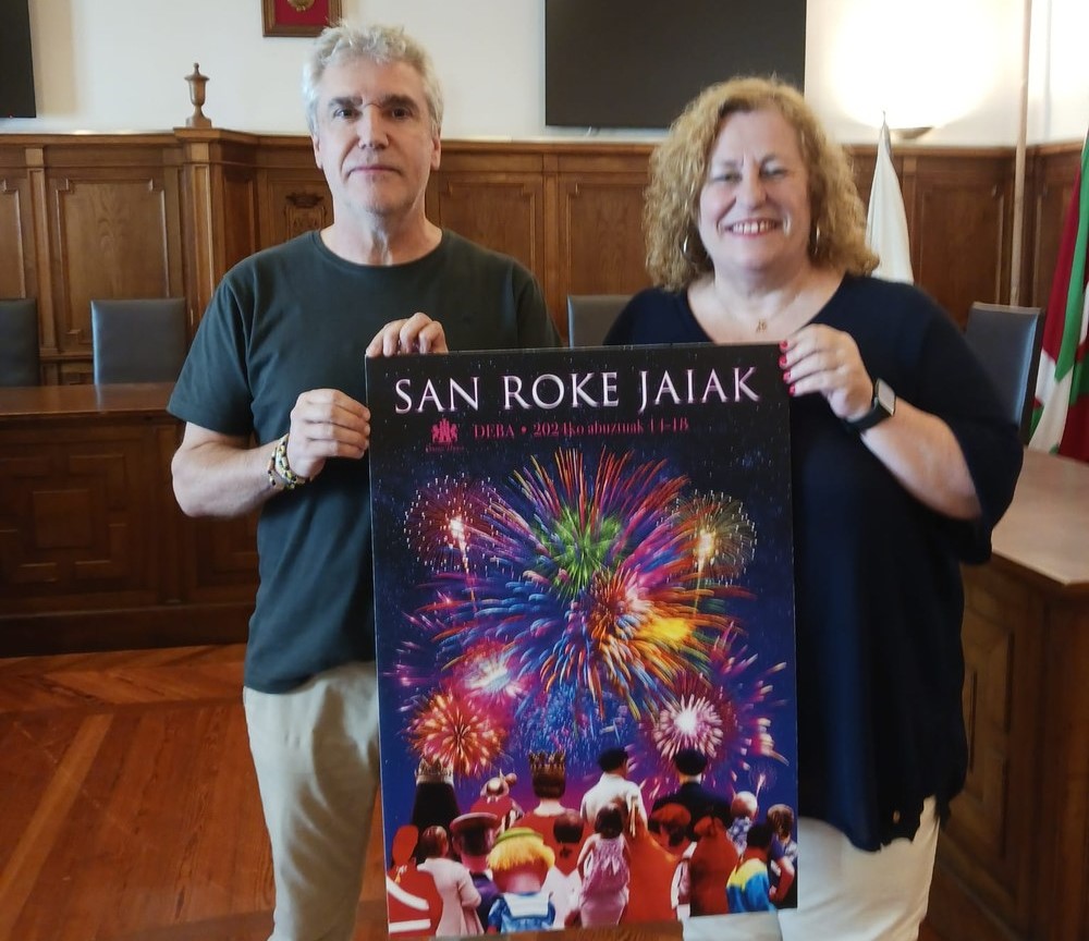 El autor del cartel ha plasmado en la imagen a las y los distintos protagonistas de las fiestas observando y disfrutando de los fuegos artificiales.